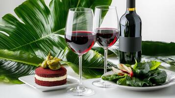 Two glasses of red wine and a cake on a table photo
