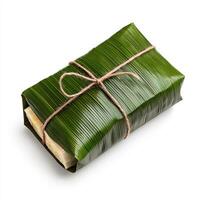 A wrapped piece of banana leaf wrapped in twine photo