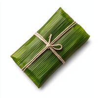 A wrapped green leaf wrapped in twine photo