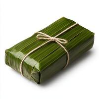 A wrapped package wrapped in green leaves photo