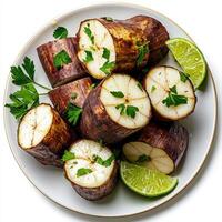 A plate of sliced potatoes with lime slices photo