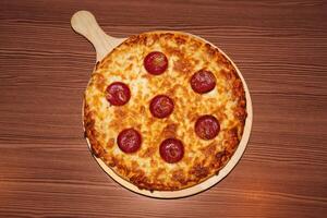 Pepperoni cheese pizza on wooden background. Retro flash food photography photo