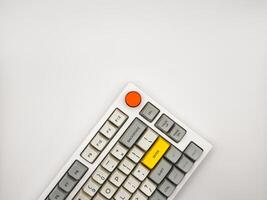 White keyboard on white background with bright red and yellow keys for advertising, space for text, top view photo