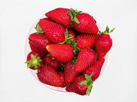 Fresh strawberries on the white background. Top view with space for text. photo