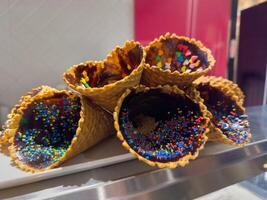 Ice cream cone with colorful sprinkles on blur background. photo