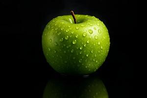 Bright green apple with water droplets lying on a black glossy surface, reflected from below. Dark background with soft blur. photo