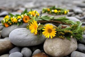 Flower crowns resting on smooth river stones photo