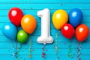 Number one balloon celebrating first birthday with colorful balloons and confetti on blue wooden background photo