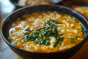 Steaming hot bowl of asian noodle soup with spinach and chicken photo