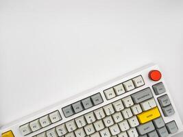 Modern mechanical keyboard isolated with red button on white background. Minimal style and design keyboard. Colorful key cap. Top view, ad. photo