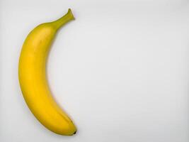 Ripe banana isolated on white background, copy space, flat lay, top view photo