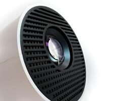 Clean projector lens macro close up view on white plastic body, copy space photo