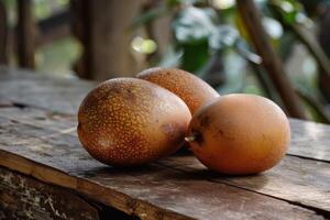 Fresh granadillas resting on rustic wooden table in natural light photo