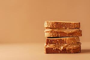 Stack of toasted sesame bread slices with peanut butter creating delicious sandwiches photo
