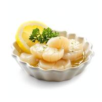 Seared scallops with lemon and parsley in a white bowl photo