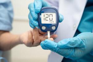doctor using digital glucose meter for check sample sugar level photo