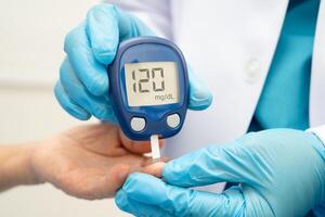 doctor using digital glucose meter check sample blood sugar level photo