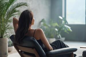 Serene Woman Relaxing in Modern Interior with Lush Greenery photo