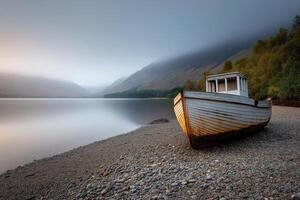 Weathered White Boat on Misty Lake Shore at Dawn photo