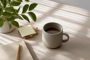 Sage Green Coffee Mug on Beige Table with Sunlight and Plant photo