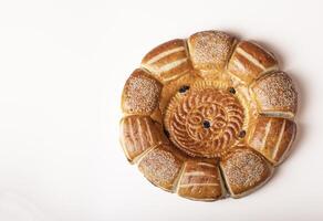 Uzbek lavash with raisins and sesame seeds isolated on white background, top view photo