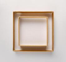 frame on white wall made of two square craft boxes, mockup, copy space photo