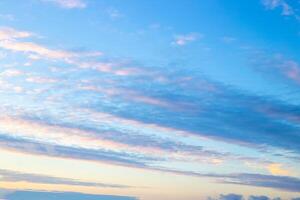 Blue evening sky with illuminated clouds at sunset. Celestial landscape. photo