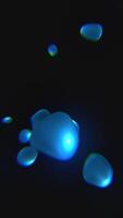 Floating blue liquid blobs in dark space, creating a glowing fluid motion effect with reflections and soft color gradients video