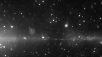 Monochrome glowing light particles scattered in the dark, creating a cosmic and mysterious atmosphere video