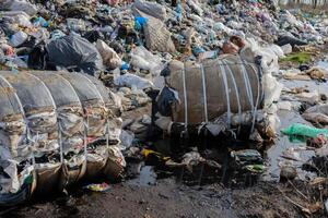 Large piles of waste and discarded materials fill the landscape, highlighting the pressing issue of pollution and improper waste management photo