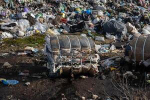 Piles of mixed debris and plastic at a landfill showcase the urgent problem of waste management and its impact on the ecosystem photo