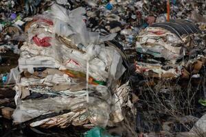 Mountains of trash and plastic debris create a serious pollution issue at a landfill site, highlighting waste management challenges photo