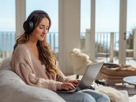 Remote worker on a call in a modern living room, wearing noise-cancelling headphones, seated at a desk with ring light and wireless keyboard, soft natural daylight from large photo