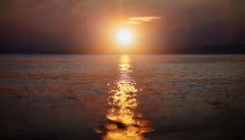 A bright sun emerging above the horizon of a smooth ocean, spreading golden light across the calm waters, evoking warmth and natural energy. photo