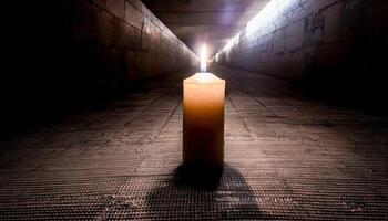 Single candle with a bright flame in the center of a dark, textured tunnel or corridor, casting a long shadow. Evokes a sense of hope and guidance in a mysterious place. photo