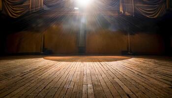 A quiet wooden stage lies empty beneath a radiant overhead spotlight. Rafters loom above, shadows hug the backdrop, and the scene hums with silent promise, waiting for the story to begin. photo
