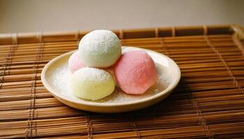 Colorful mochi ice cream balls on rustic bamboo tray, traditional Japanese dessert. photo