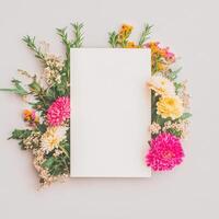 Blank Card Framed by Assorted Flowers and Greenery photo