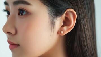 Close-up profile view of a woman's face and earrings. photo