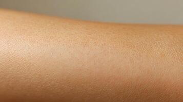 Closeup view of a smooth, light tan human arm. photo