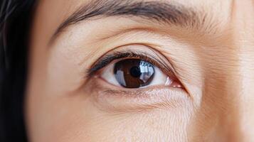 Close-up view of a woman's eye with visible wrinkles. photo
