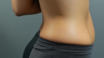Close-up view of a woman's midsection and lower abdomen. photo