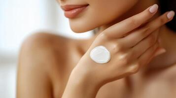 Close-up of a woman's hand applying lotion. photo