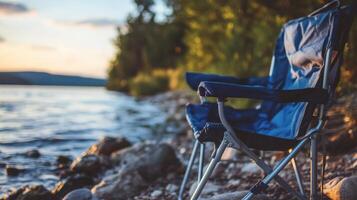 Lakeside folding chair bathed in golden light. photo