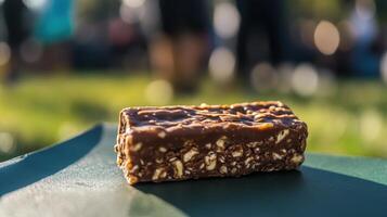 Chocolate energy bar on a dark plate outdoors. photo