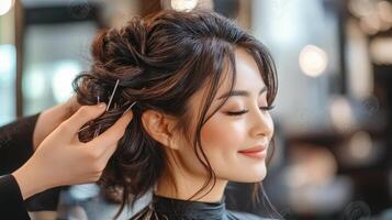 Stylish updo being expertly crafted on a woman's head. photo