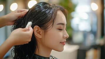 Close-up of a person receiving a hair treatment. photo
