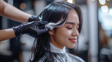 A woman's hair being colored in a salon. photo