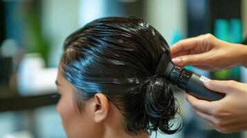 Closeup view of a person's hair being styled in a salon. photo