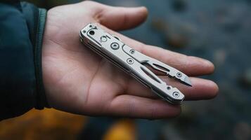 Close-up of a compact multi-tool in a hand. photo